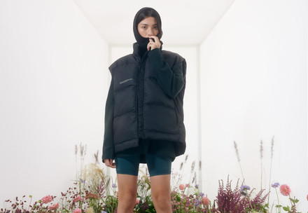 Woman in a outerwear vest standing in a flower field