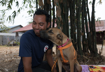 Animal caregiver and dog Jackson cuddling